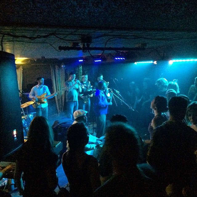 a band is performing in the dark during a party