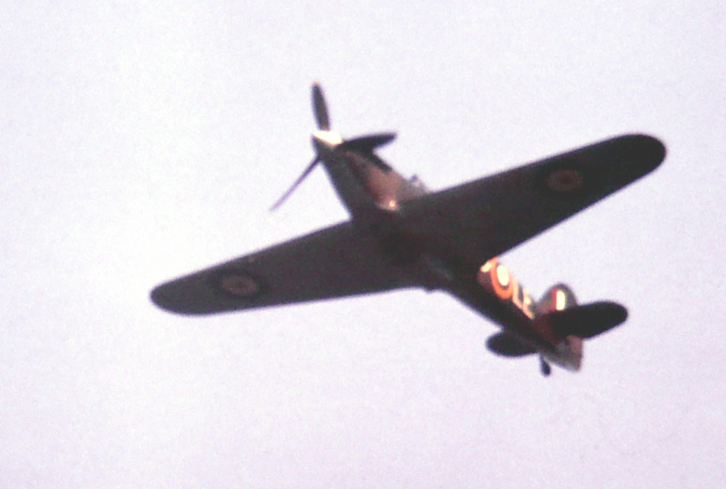 a propeller airplane flying up in the sky