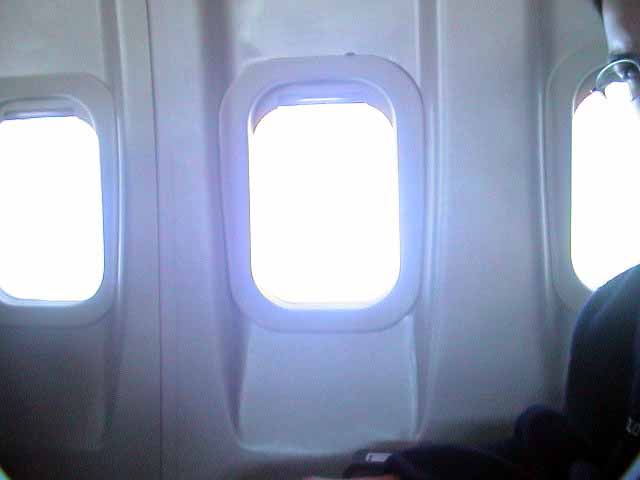 the two windows in this airplane have no people inside