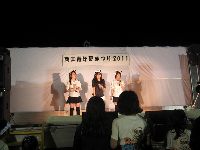 some s at a stage wearing school uniforms