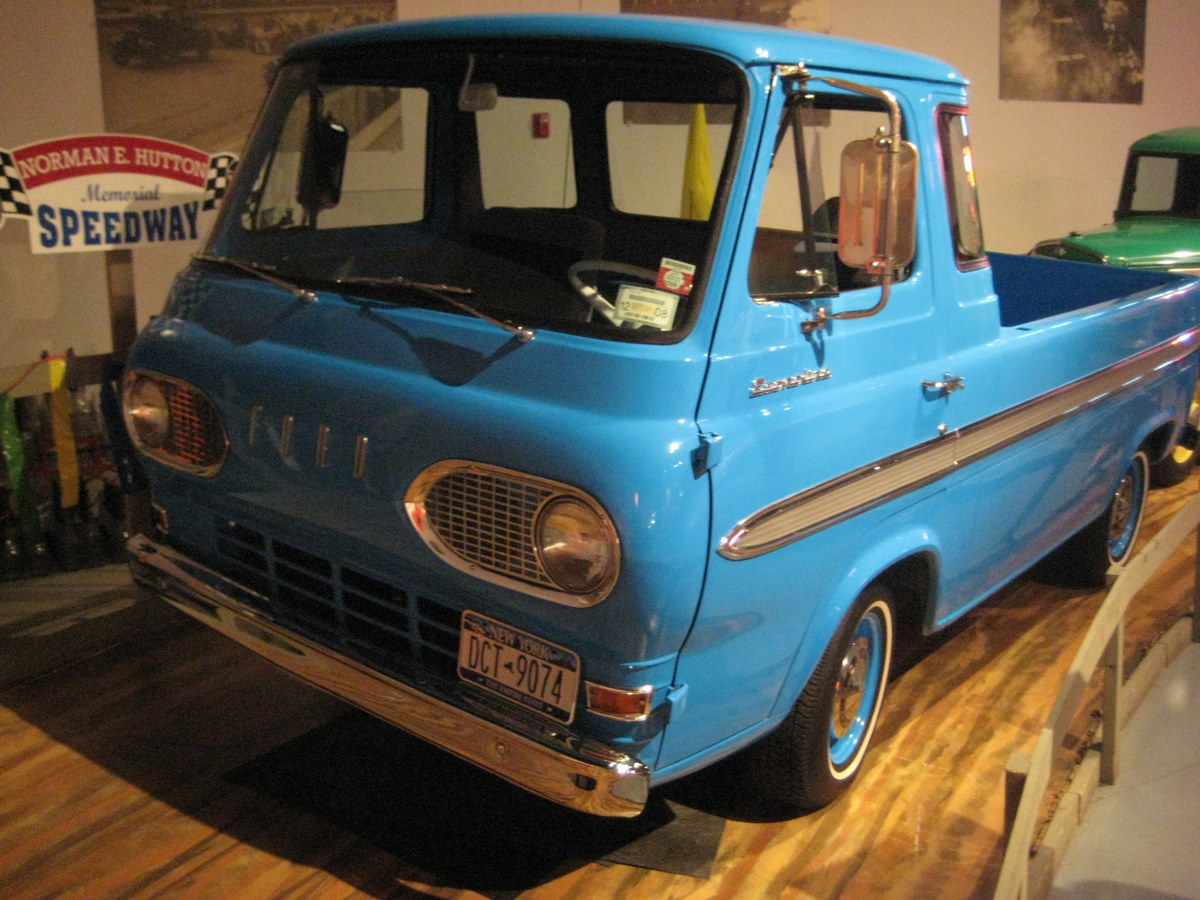the old blue pickup truck is displayed in a museum