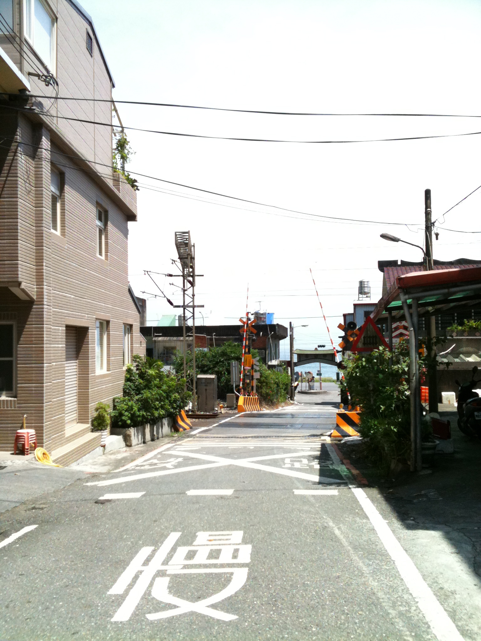 a wide city street has a red and white sign pointing the way