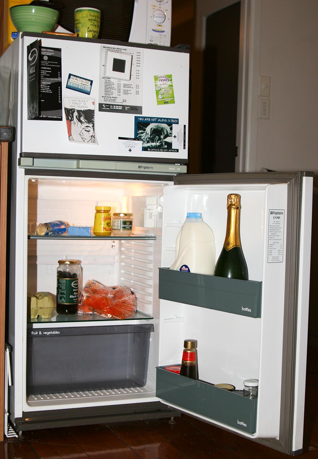 a fridge is open with some bottles and beverages inside