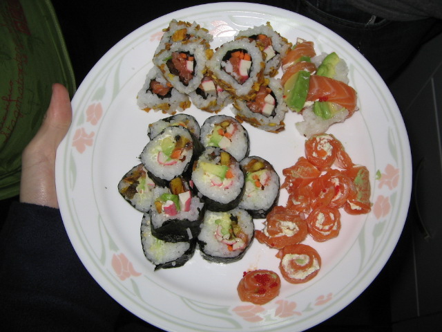 a person holds up a plate of sushi