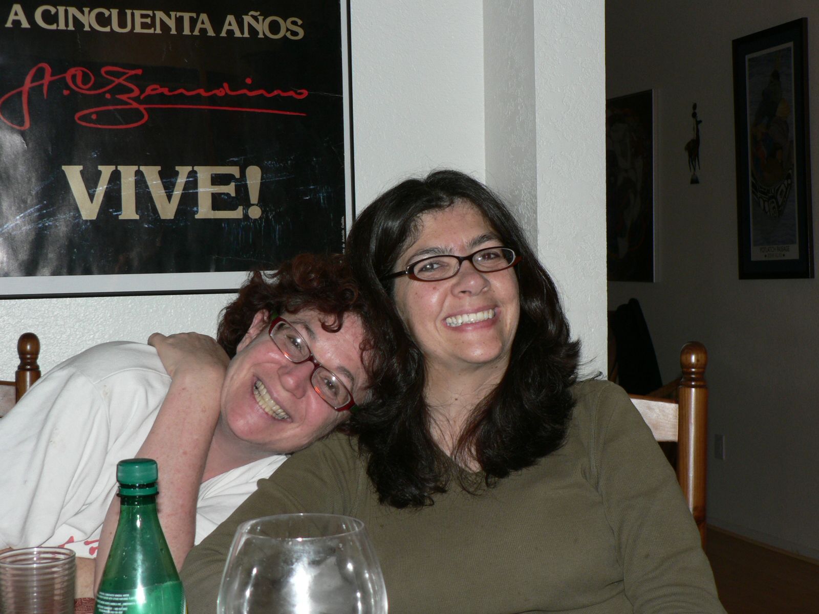 two women smiling and leaning on each other