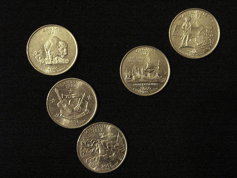 gold coins are scattered along a black table