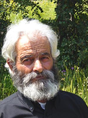 a man with grey beard and white hair and black shirt