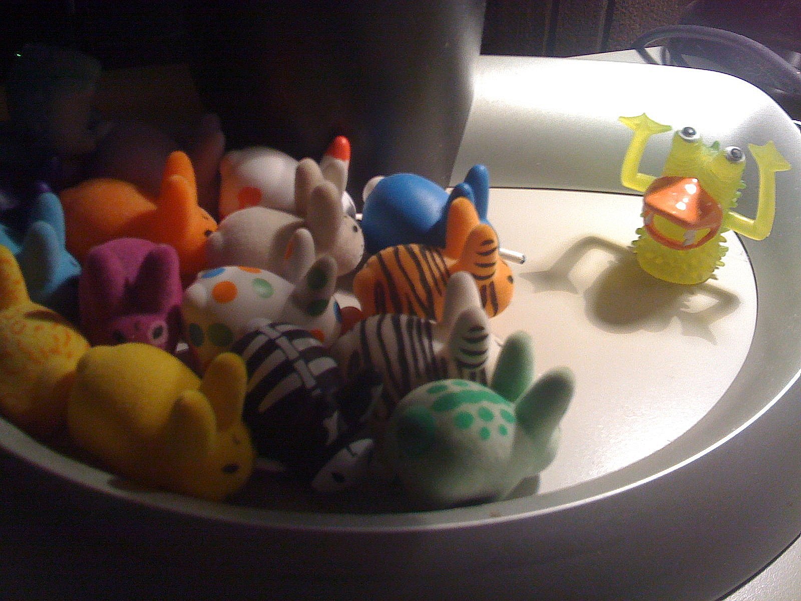 there are many small colorful stuffed animals in the sink