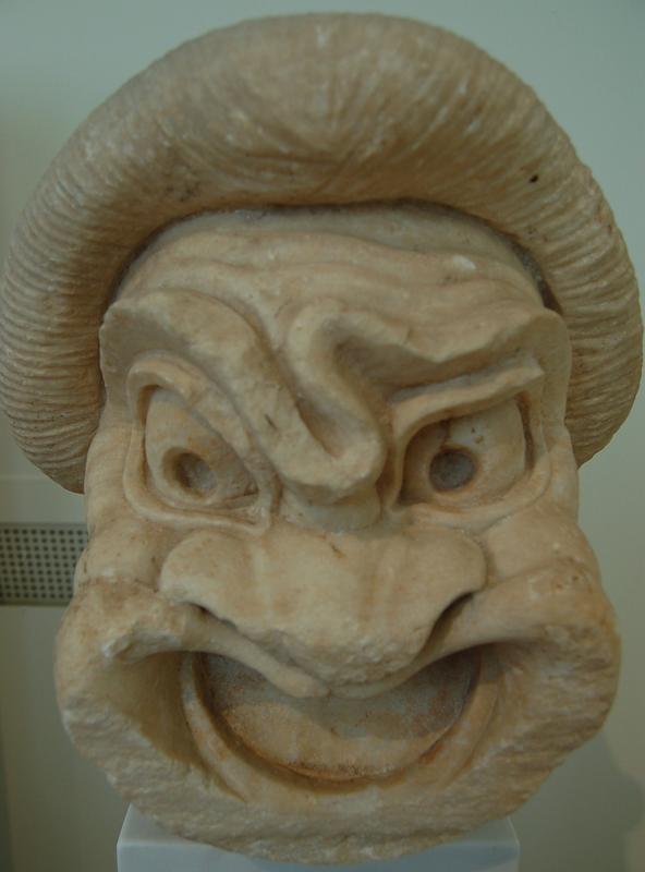 a sculpture of an angry mean with horns