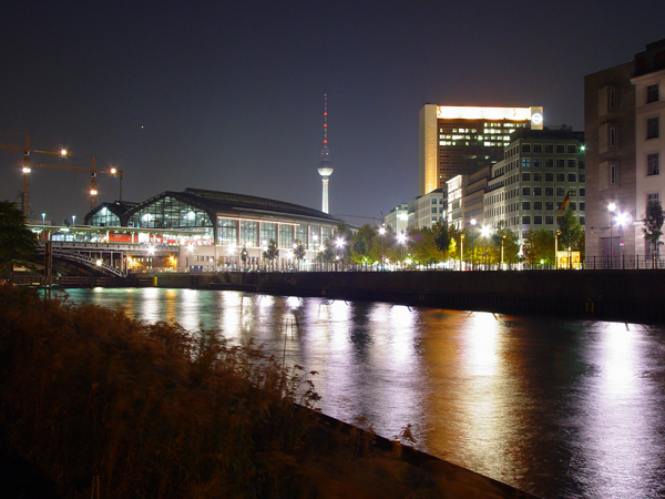 a nighttime view of the city with river running through it