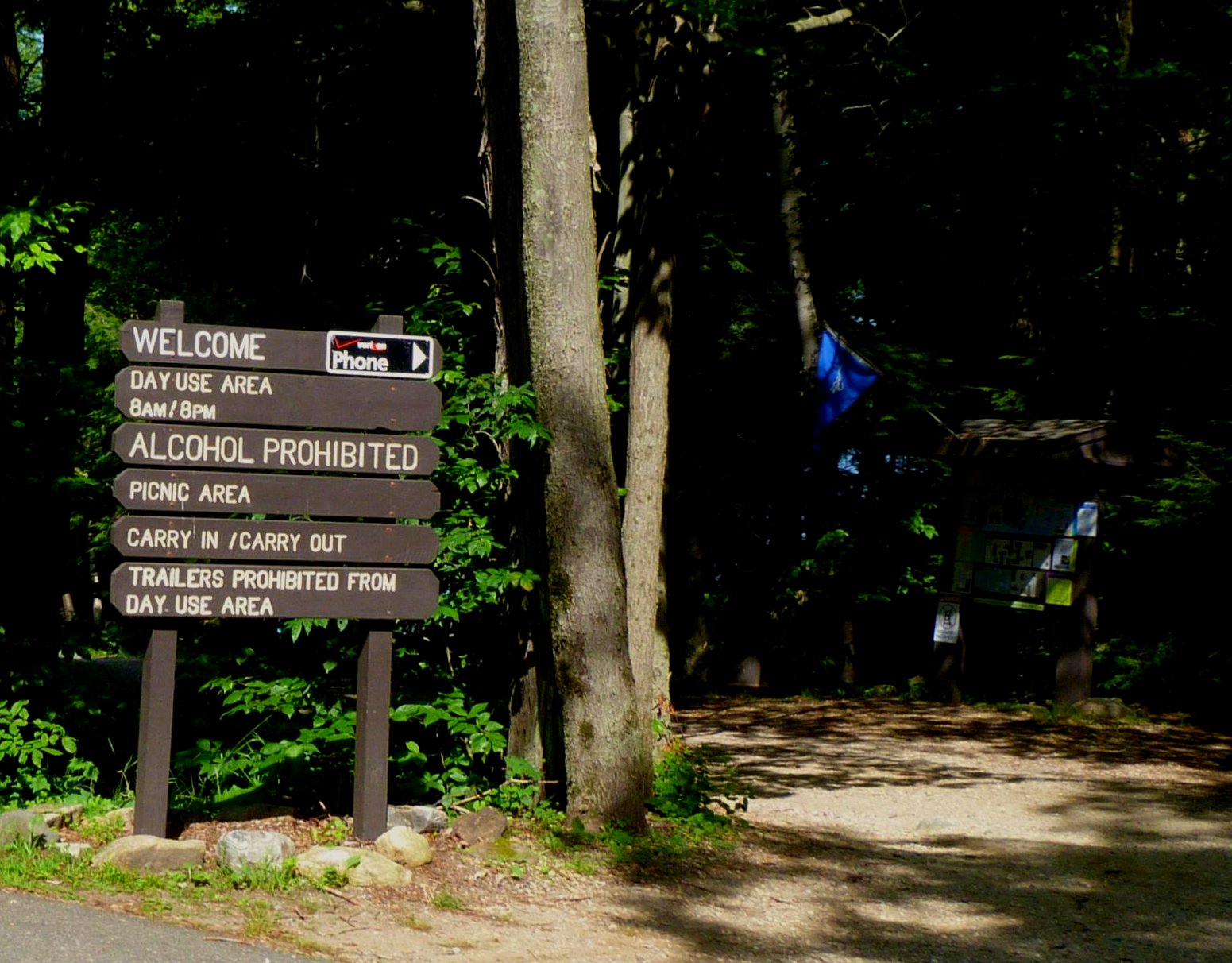 a sign is shown beside a couple of trees