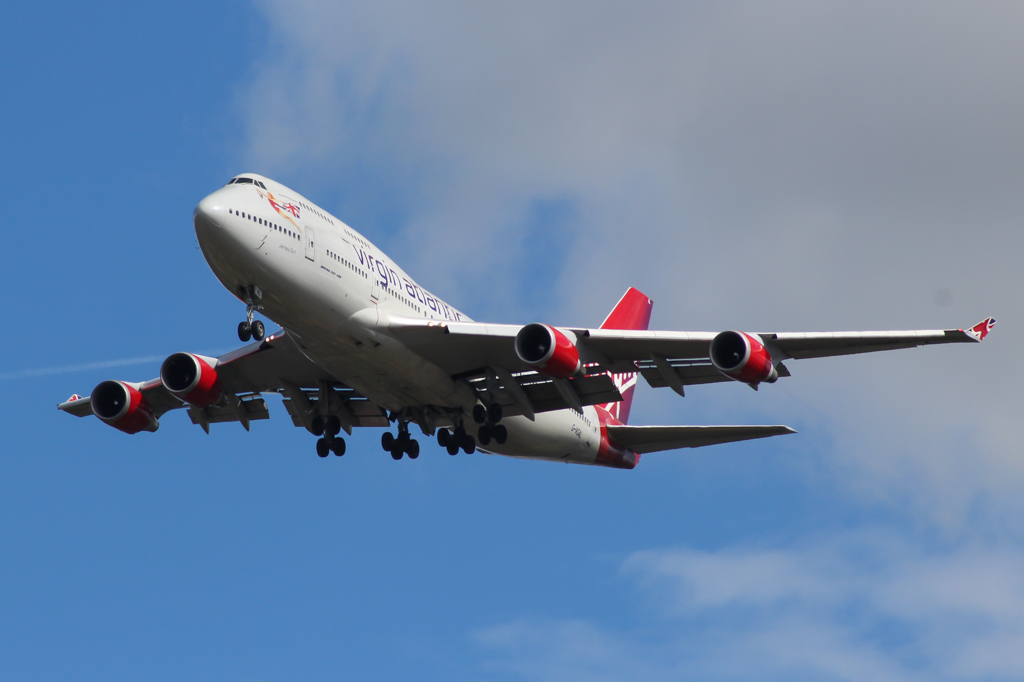 an airplane is flying in the air against a blue sky