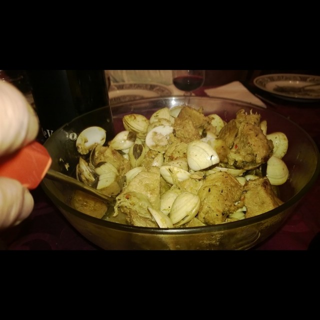 a bowl filled with some food next to a knife