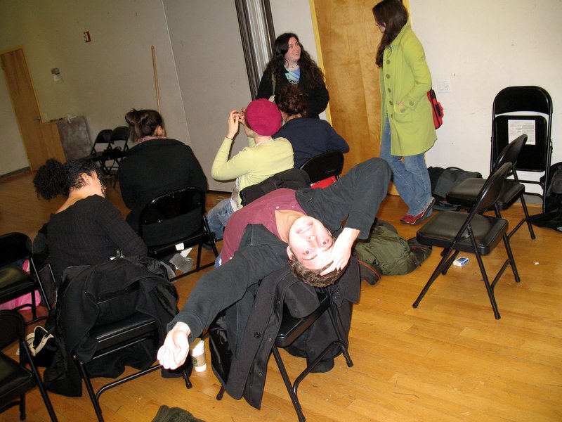 a group of people are sitting in chairs and posing