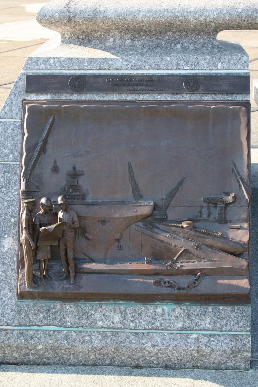 a man in uniform standing next to a memorial