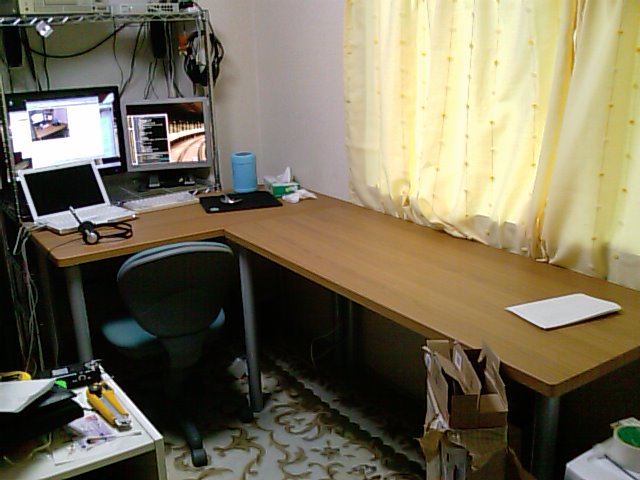 a corner office desk with a desktop computer