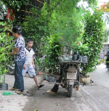 two people are standing next to a motorcycle