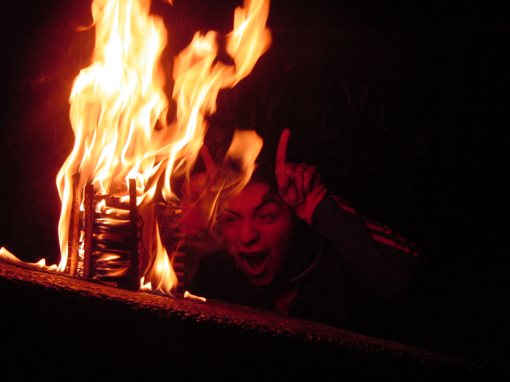 a person standing in front of a fire