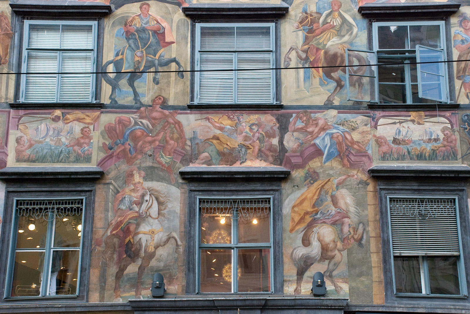 a building with some windows decorated with paintings