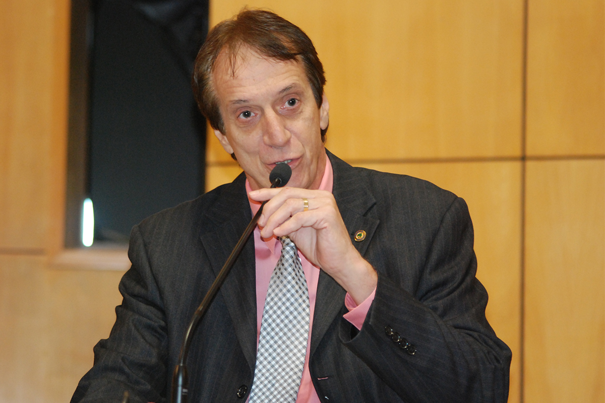 a man is holding a microphone while speaking