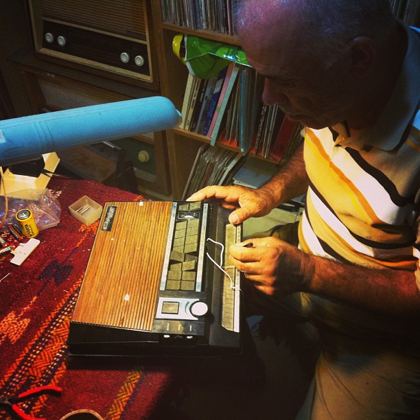 a man uses a small laptop computer on his lap