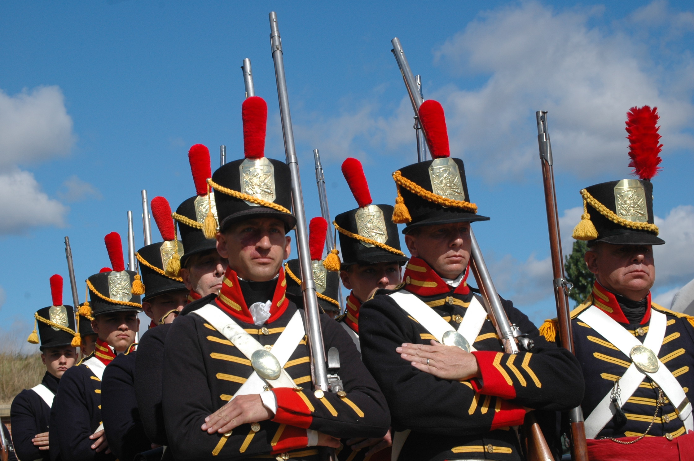 the marching team is wearing colorful hats and uniform