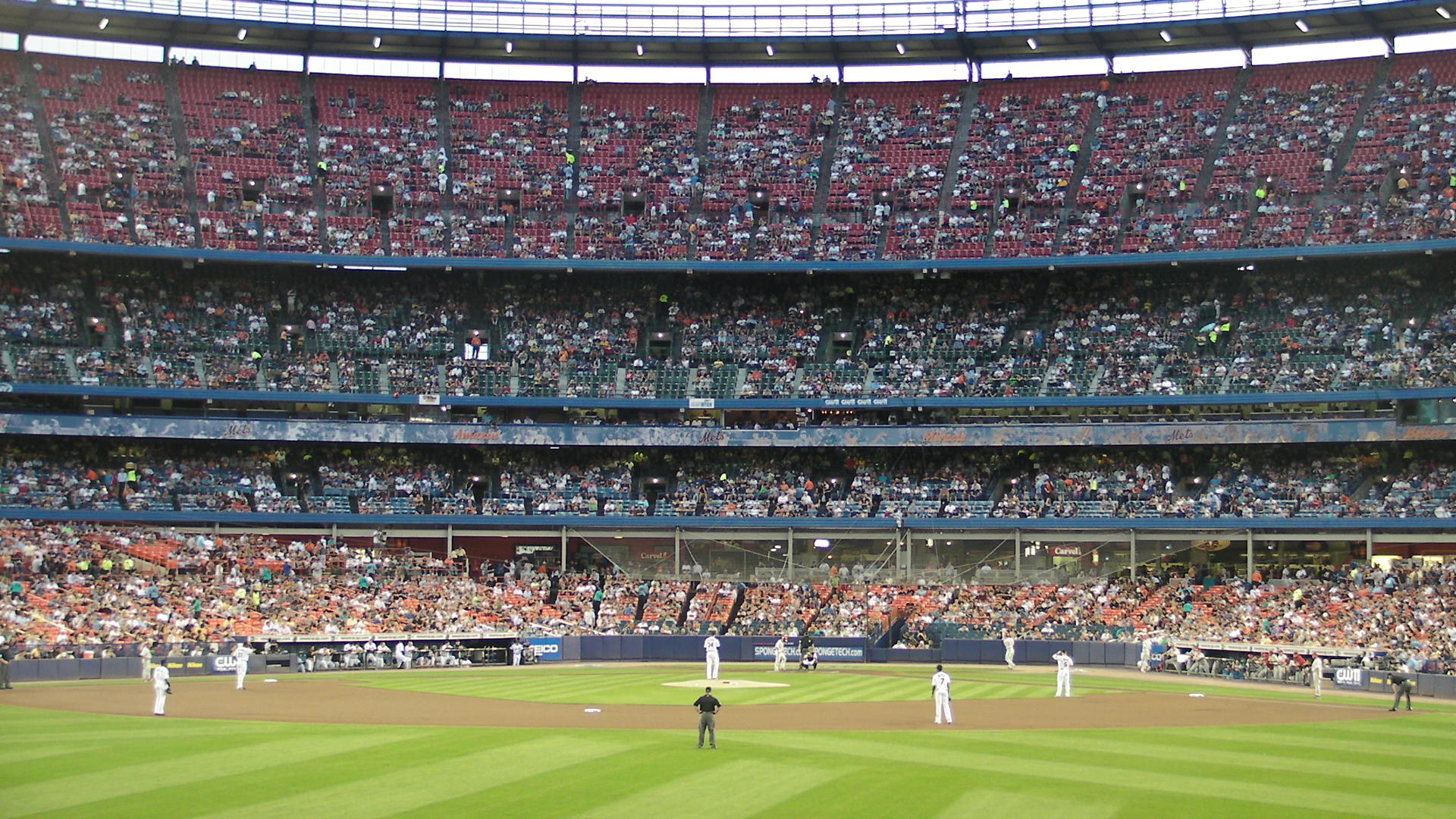 a crowd is watching a baseball game in progress