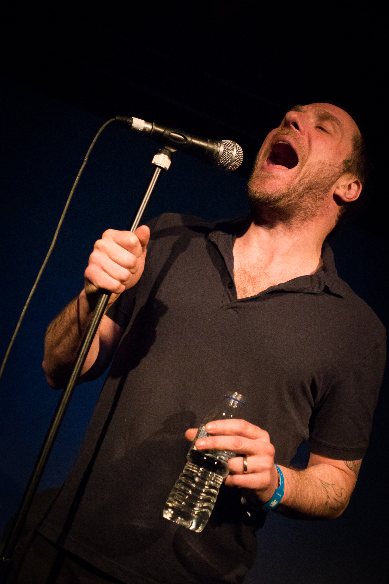 a person that is singing into a microphone
