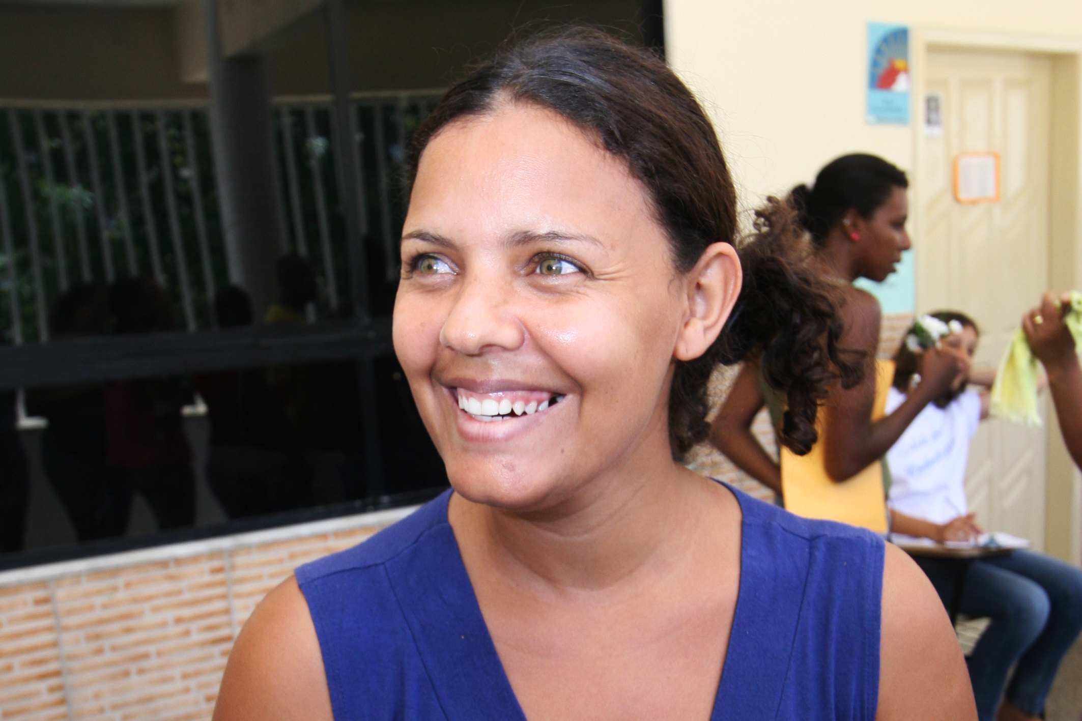 a woman in blue smiling for a po