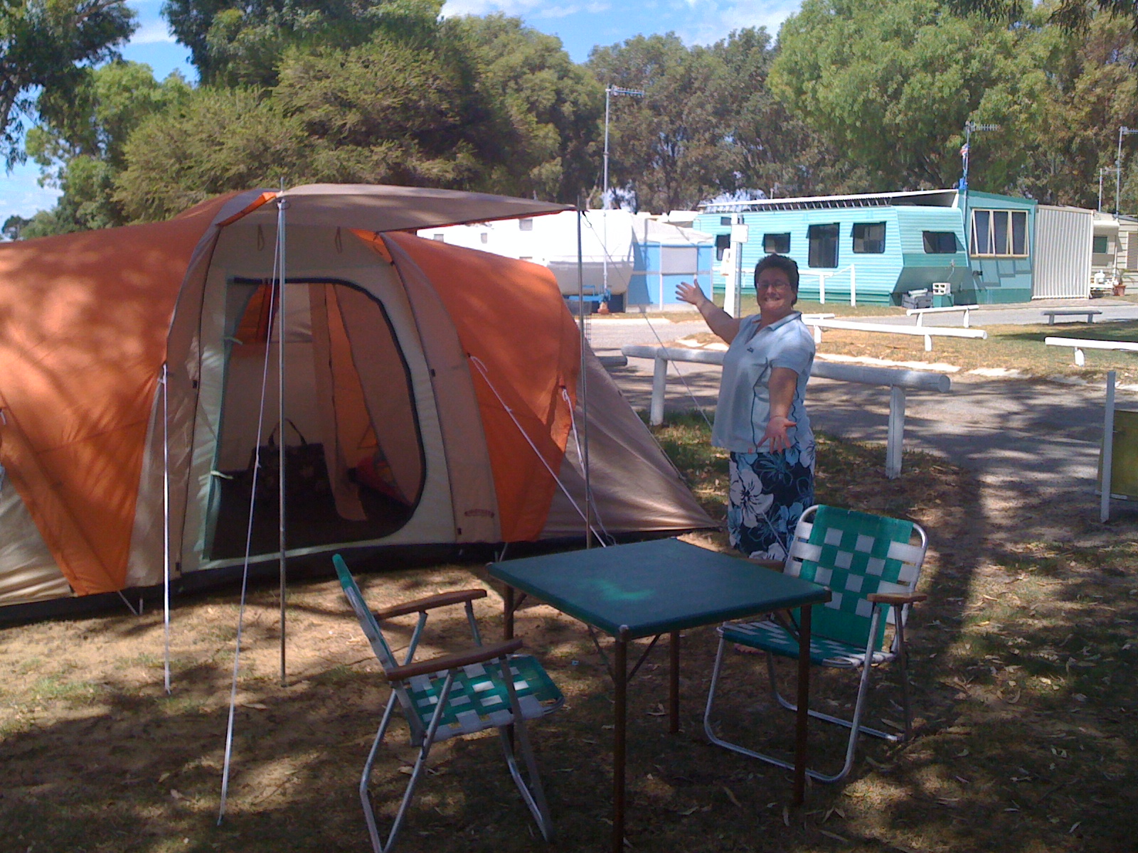 a young man sitting outside of his tent