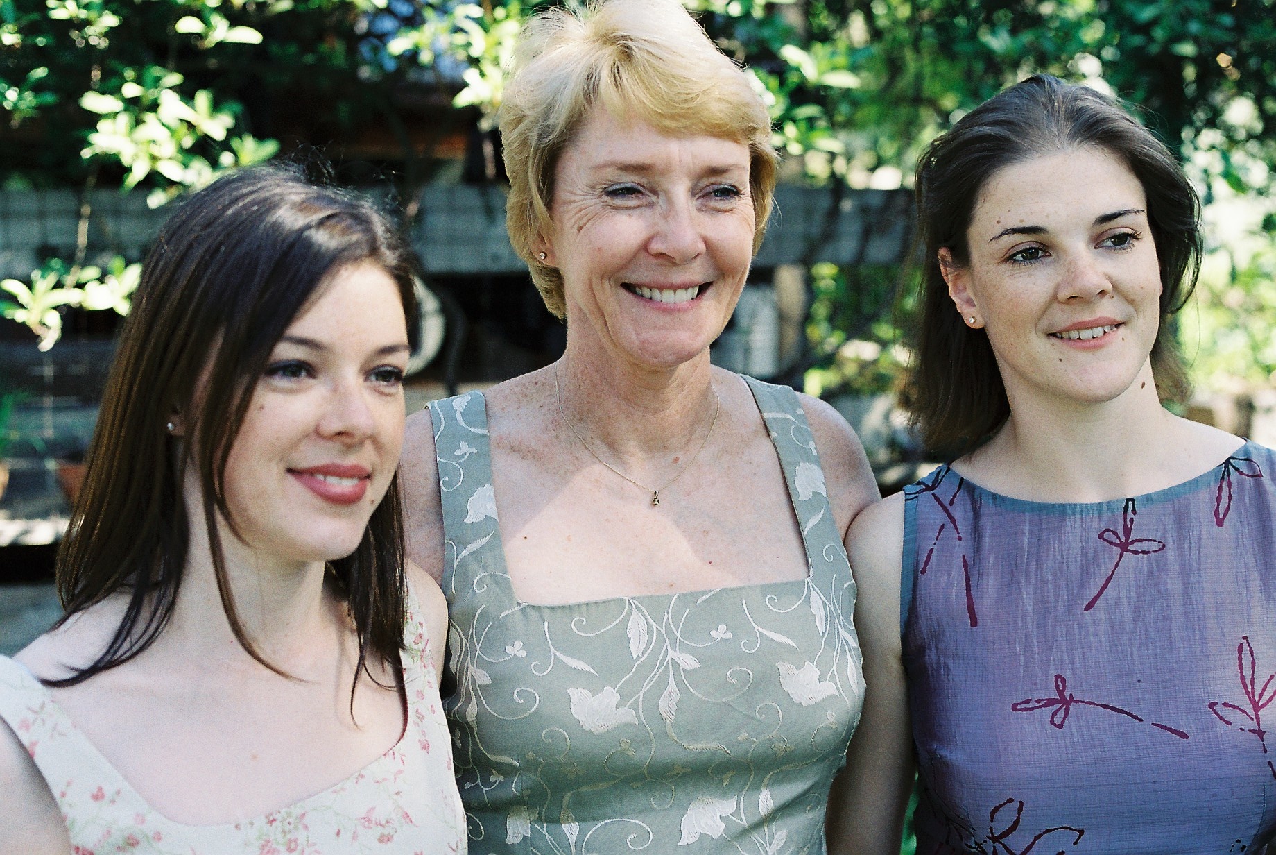 a group of four women standing next to each other