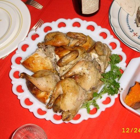 a table with plates, silverware, and dishes filled with chicken