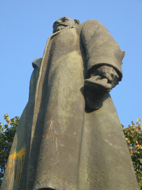 a statue is shown against a bright blue sky