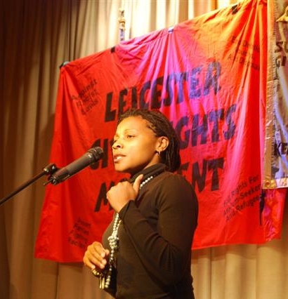 the woman stands at a podium to speak into a microphone