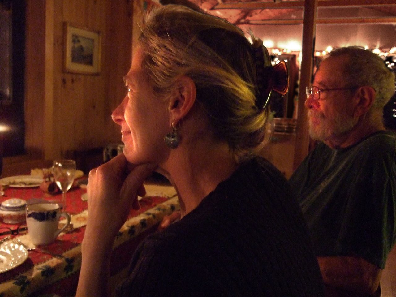 two people at a dinner table looking off into the distance