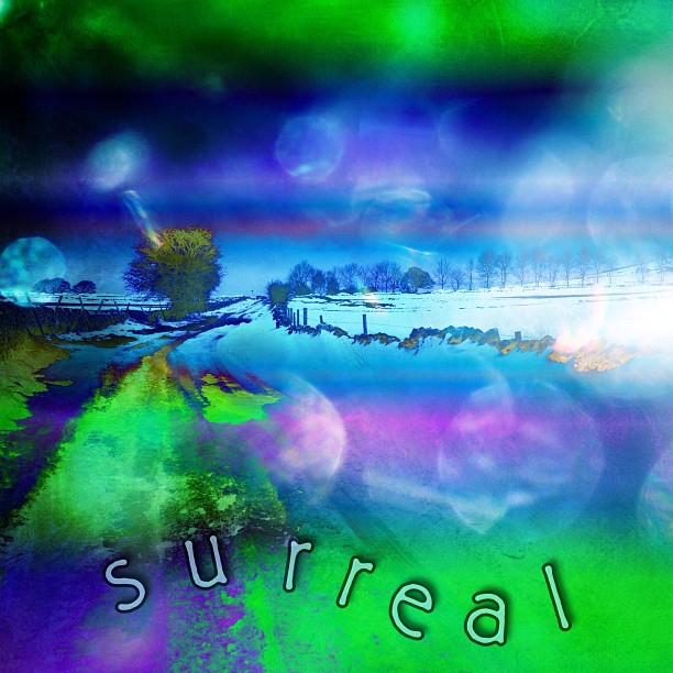 a blurry pograph of the word surreal written in blue