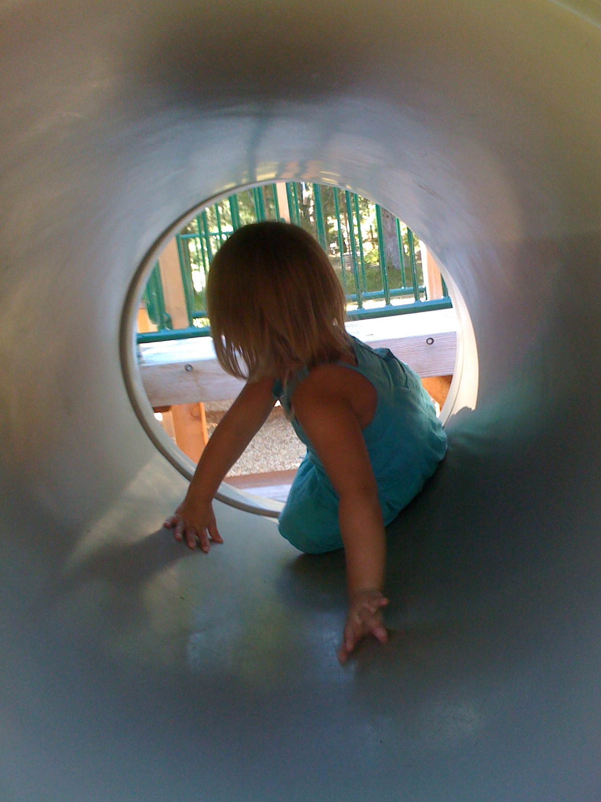 a child is playing in a tube on the ground