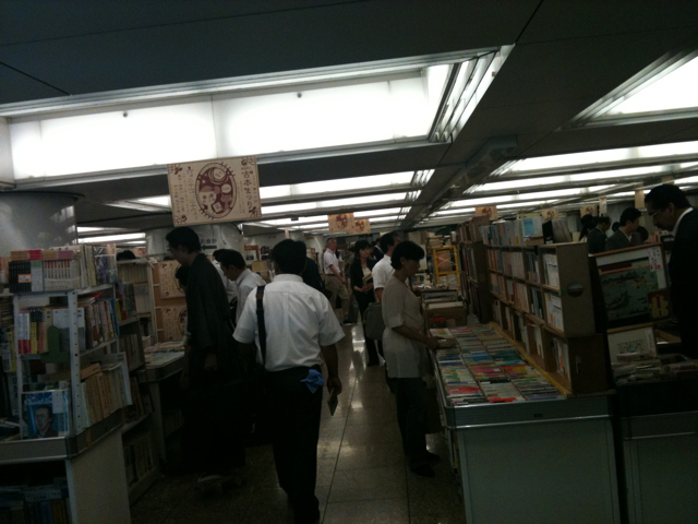 an interior view of a bookshop with people browsing