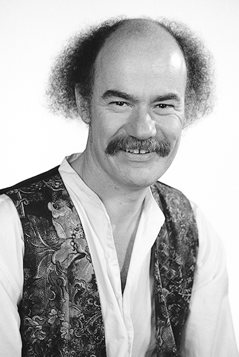 an older man has a mustache and has hair in curly curls