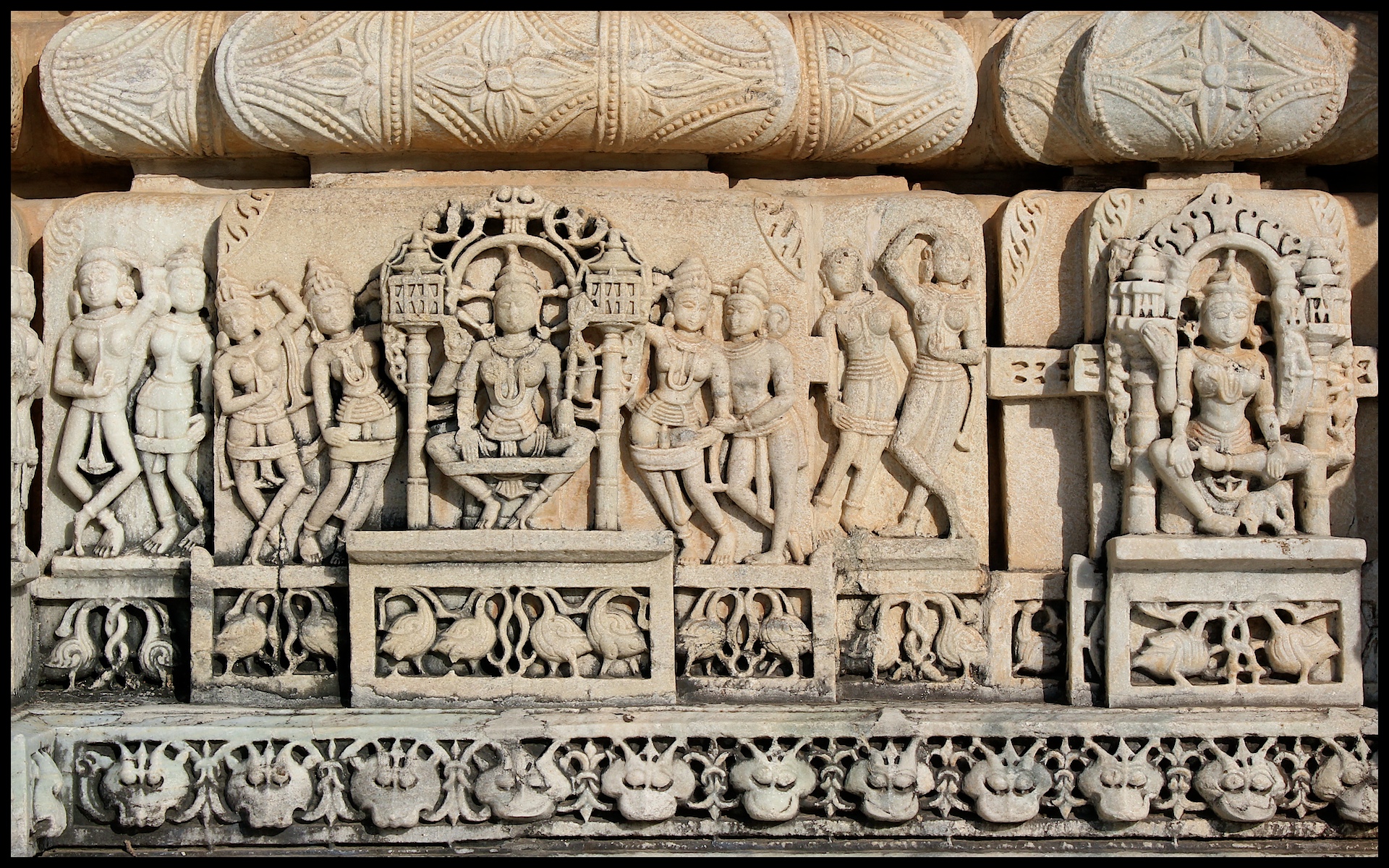 a carved stone carving of indian gods and goddesss