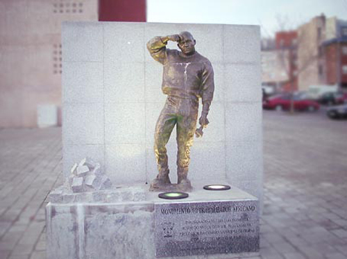 a small statue of a soldier is placed on the sidewalk