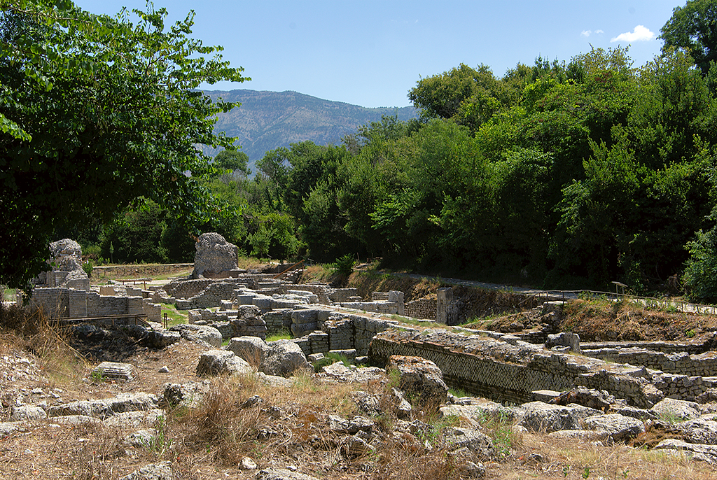 the remains of ancient greek ruins are strewn about