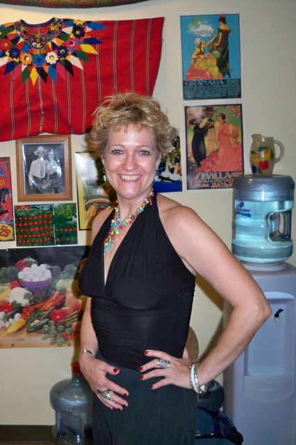 a woman posing in a room decorated with pictures and accessories