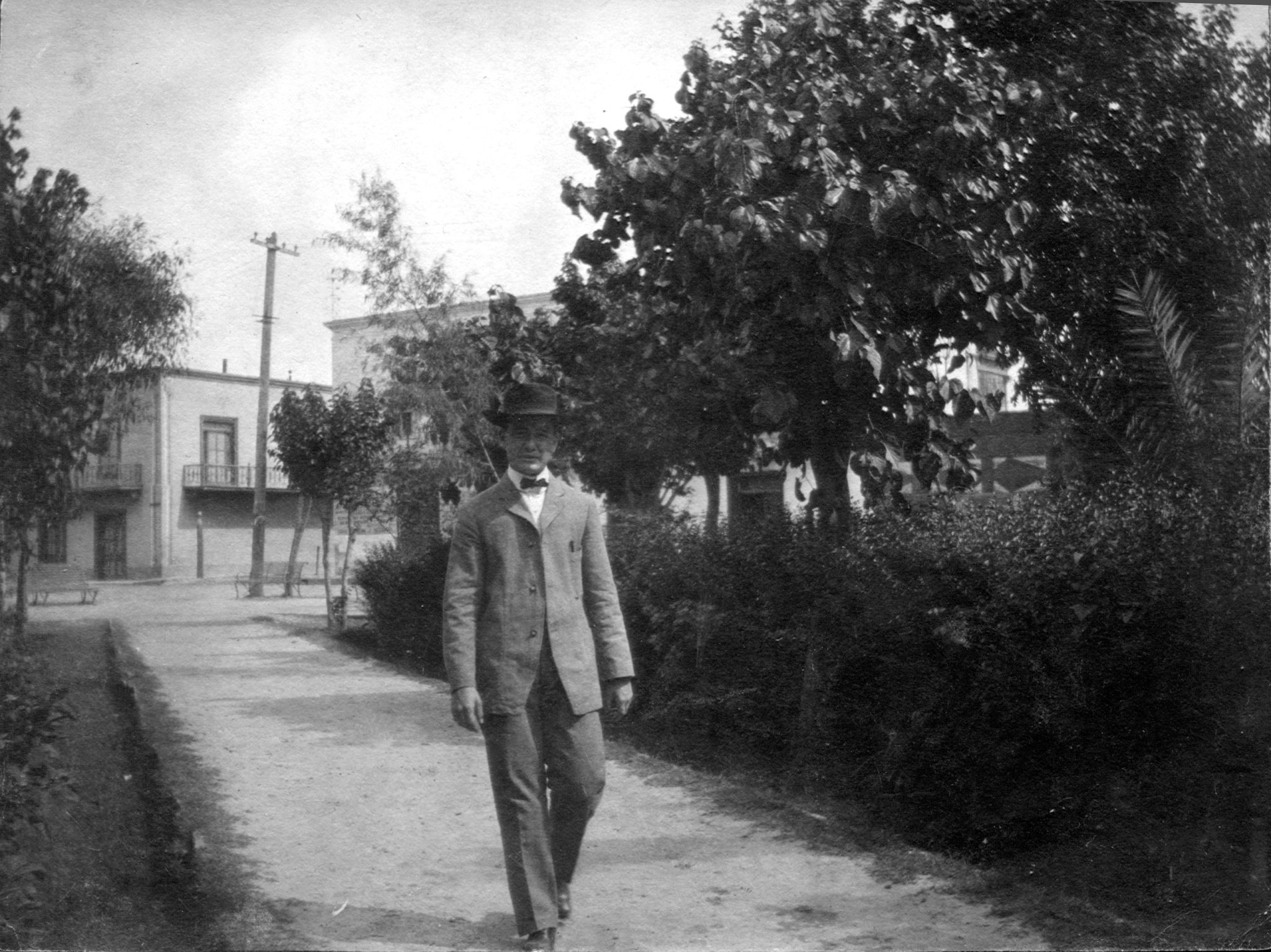 black and white po of man walking down the path