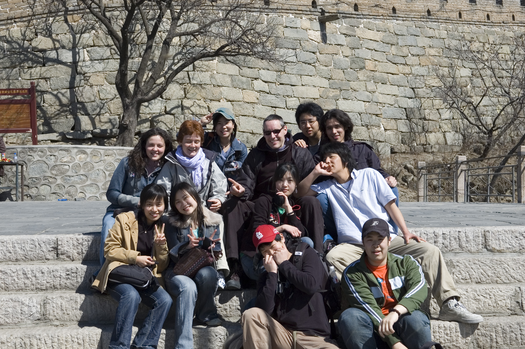 a group of people posing for a picture on a stone steps