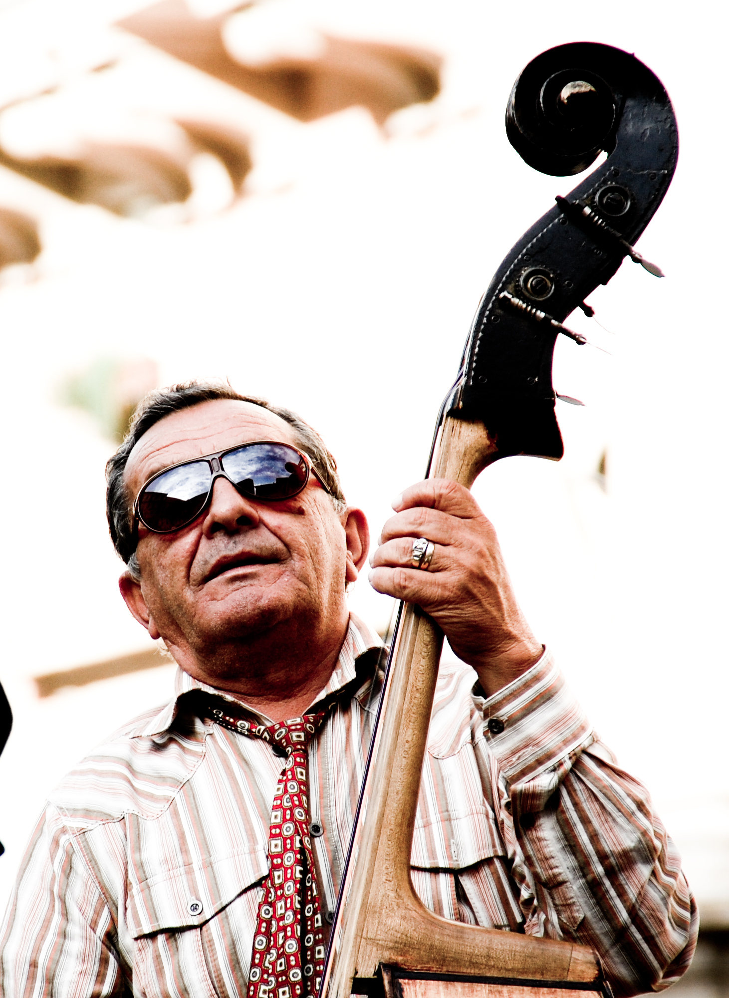 a man in a tie holding a musical instrument