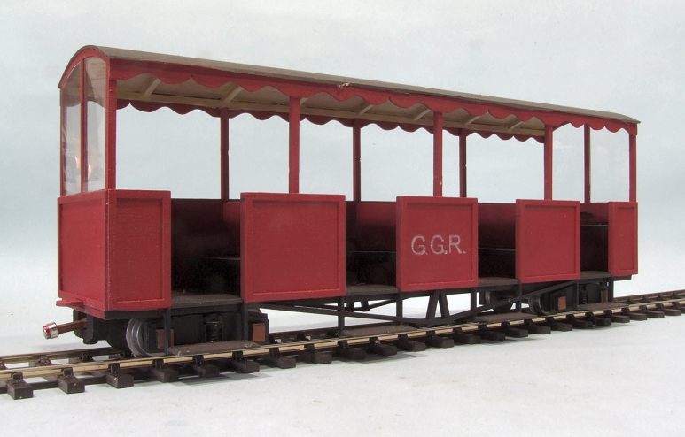 a model train caboose with three carts and four doors
