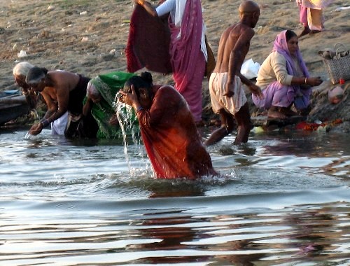 a group of people are gathering around in water