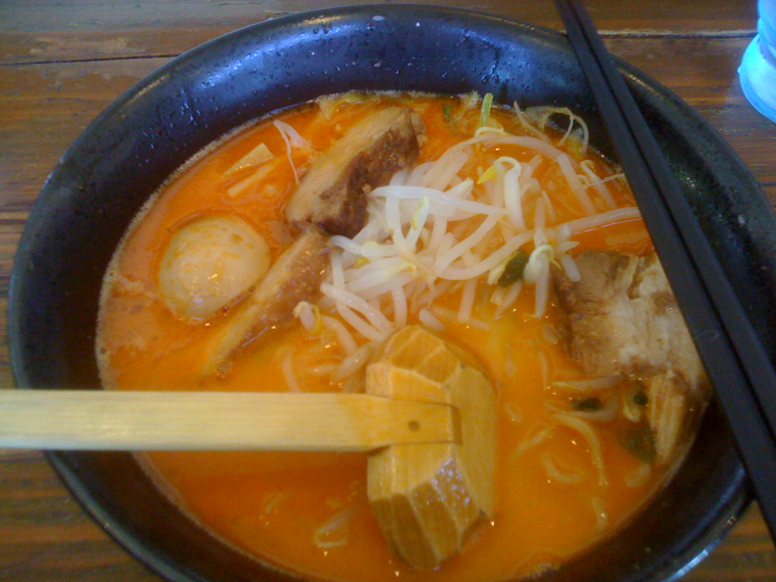 a bowl of noodles soup and chop sticks