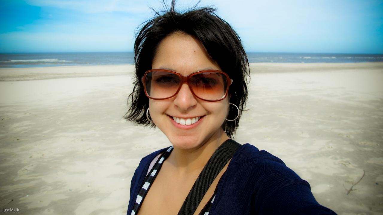 the woman is taking a selfie on the beach